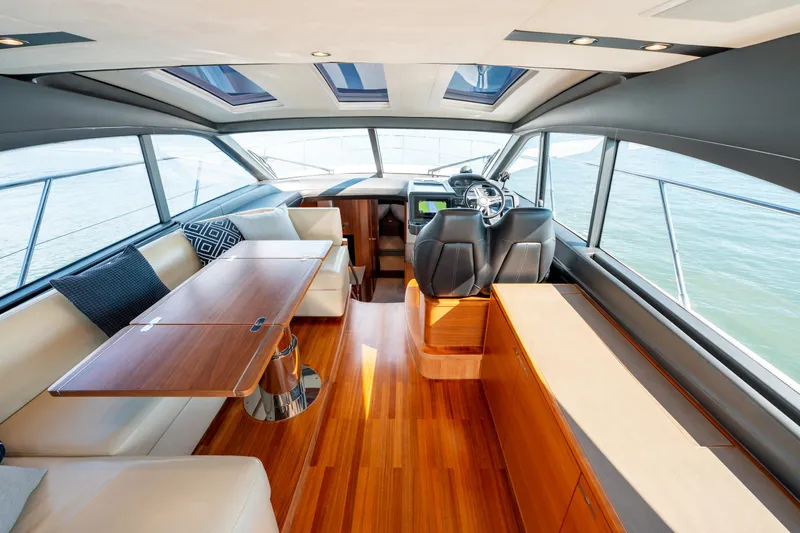  Yacht Photos Pics Luxurious interior of 2015 Princess V48 yacht with elegant seating and wooden finishes.
