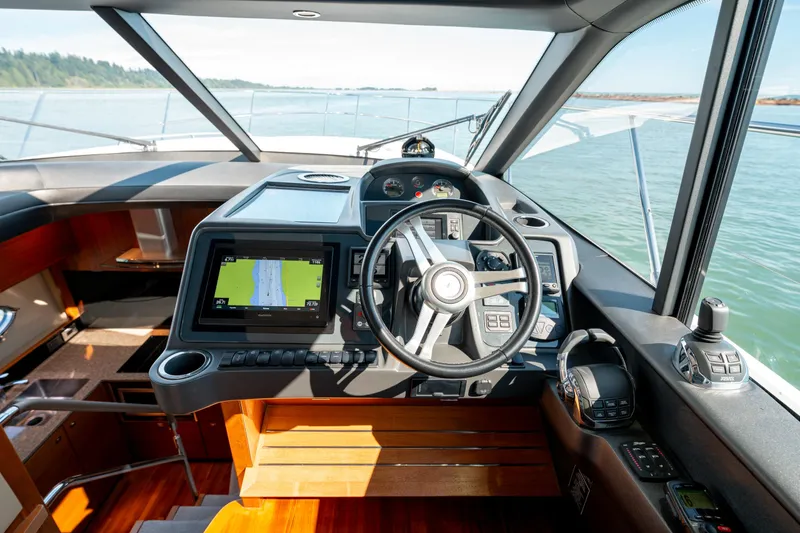  Yacht Photos Pics Interior view of 2015 Princess V48 yacht cockpit with navigation system and steering wheel.