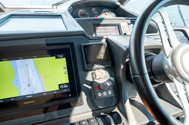  Yacht Photos Pics Control panel of a 2015 Princess V48 yacht with navigation display and steering wheel.