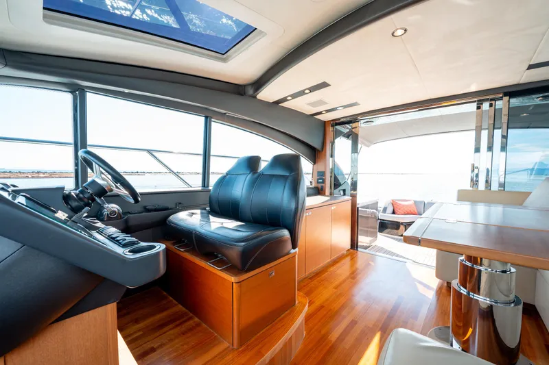  Yacht Photos Pics Luxurious interior of 2015 Princess V48 yacht with leather seating and wooden flooring.