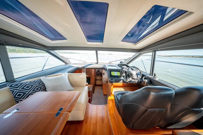  Yacht Photos Pics Luxurious interior of 2015 Princess V48 yacht with leather seating and panoramic windows.