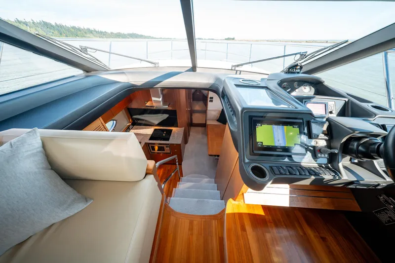  Yacht Photos Pics Interior of 2015 Princess V48 yacht, featuring modern navigation equipment and luxurious seating.