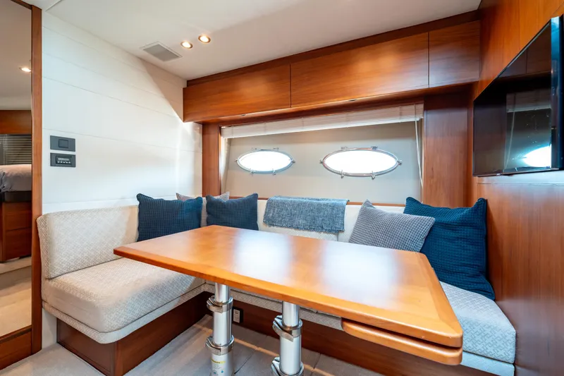  Yacht Photos Pics Luxurious 2015 Princess V48 yacht interior with cozy seating and elegant wooden finishes.