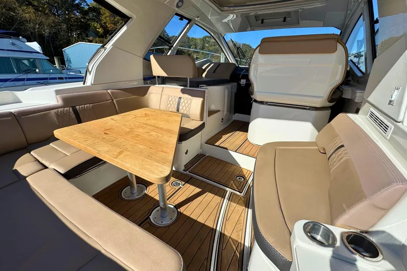  Yacht Photos Pics 2017 Sea Ray Sundancer 350 Coupe interior with elegant seating and wooden table.