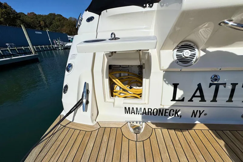  Yacht Photos Pics 2017 Sea Ray Sundancer 350 Coupe docked, showing storage compartment and marina background.