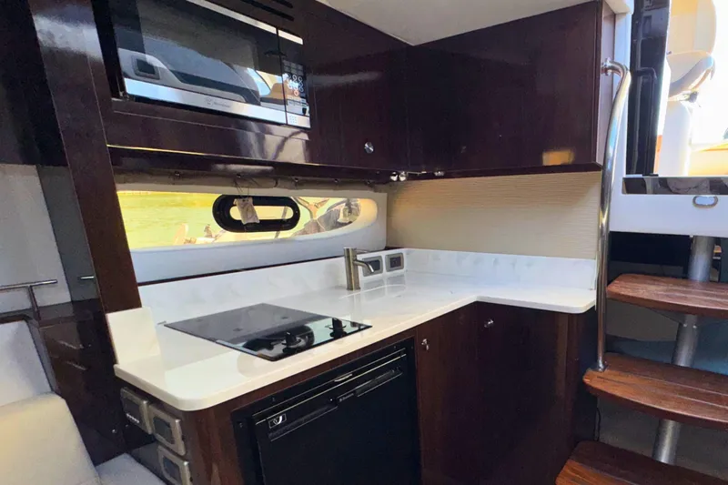  Yacht Photos Pics Luxurious 2017 Sea Ray Sundancer 350 Coupe yacht kitchen with modern appliances and sleek design.