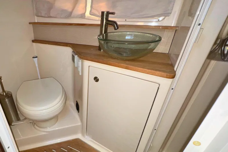  Yacht Photos Pics 2017 Sea Ray Sundancer 350 Coupe bathroom with glass sink and wooden countertop.
