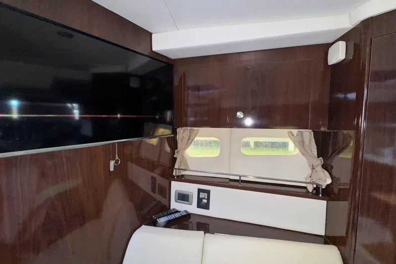  Yacht Photos Pics Interior of 2017 Sea Ray Sundancer 350 Coupe with TV and wood paneling.