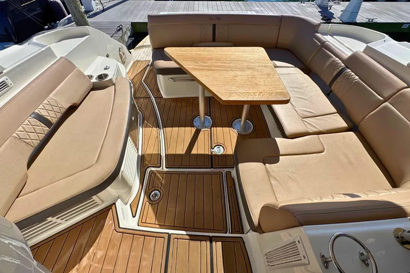 Yacht Photos Pics Luxurious seating area on 2017 Sea Ray Sundancer 350 Coupe yacht with wooden table.
