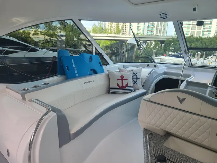  Yacht Photos Pics Interior of a 2007 Formula 45 Yacht with white seating and nautical decor.