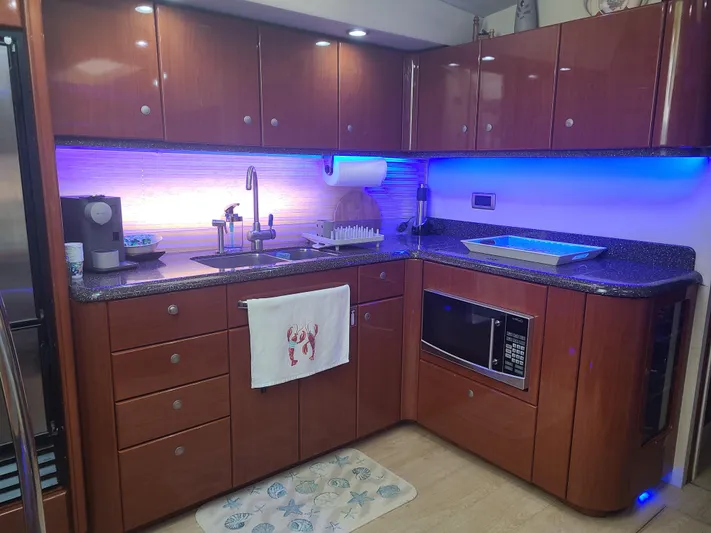  Yacht Photos Pics Modern kitchen in 2007 Formula 45 Yacht with wood cabinets and blue LED lighting.
