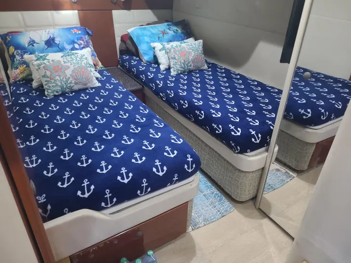  Yacht Photos Pics Twin beds with nautical-themed bedding in a 2007 Formula 45 Yacht cabin.