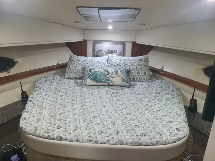  Yacht Photos Pics Luxurious bedroom in a 2007 Formula 45 Yacht with a cozy bed and marine-themed decor.