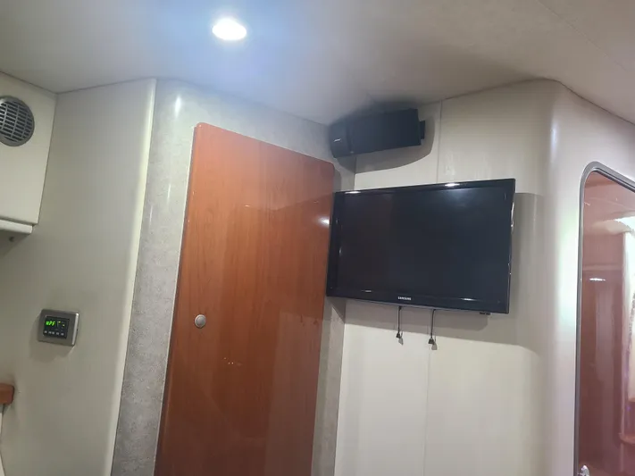  Yacht Photos Pics Interior of a 2007 Formula 45 Yacht with mounted TV and wooden door.