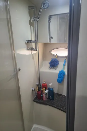  Yacht Photos Pics 2007 Formula 45 Yacht bathroom with shower, toiletries, and cleaning supplies.