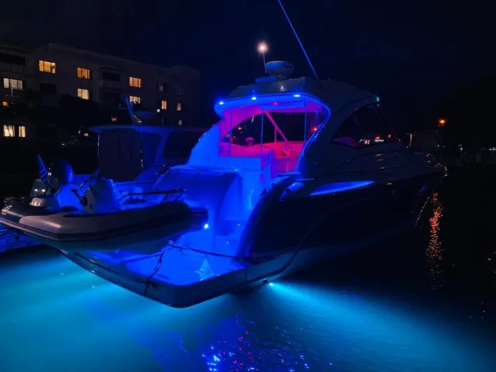  Yacht Photos Pics 2007 Formula 45 Yacht illuminated with blue and red lights at night.