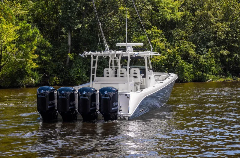  Yacht Photos Pics 2018 Everglades 435 Center Console boat with four engines on a calm river.