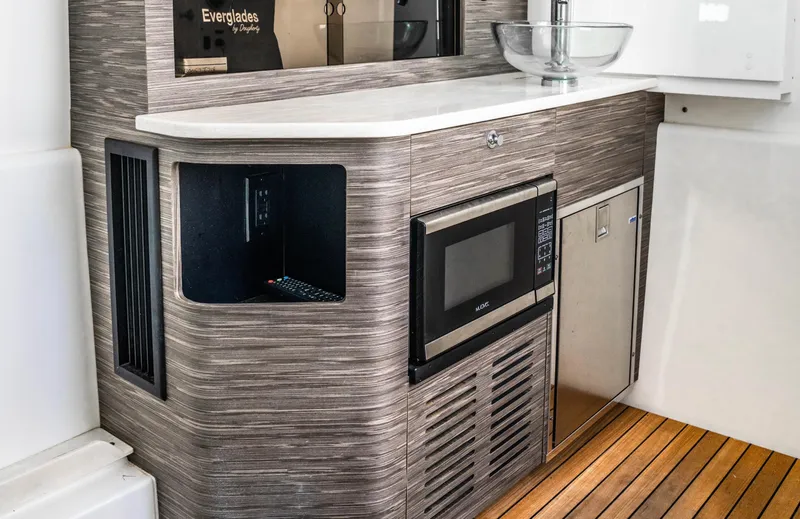  Yacht Photos Pics 2018 Everglades 435 Center Console interior with microwave and modern cabinetry.