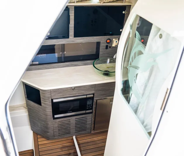  Yacht Photos Pics Interior of 2018 Everglades 435 Center Console with modern kitchenette and appliances.
