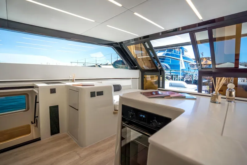 R2d2 Yacht Photos Pics Luxurious interior of 2025 Sunreef 55 Ultima yacht with modern kitchen and panoramic windows.