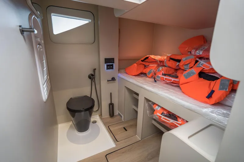 R2d2 Yacht Photos Pics Modern Sunreef 55 Ultima 2025 yacht interior with life jackets and compact bathroom.