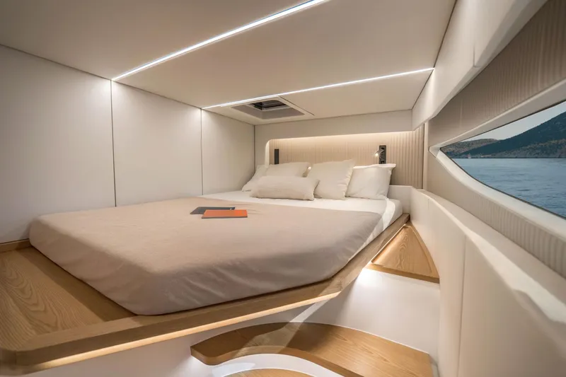 R2d2 Yacht Photos Pics Luxurious interior of 2025 Sunreef 55 Ultima yacht with elegant bed and scenic window view.