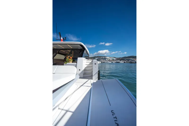 R2d2 Yacht Photos Pics 2025 Sunreef 55 Ultima yacht with sleek design, docked in a serene marina.