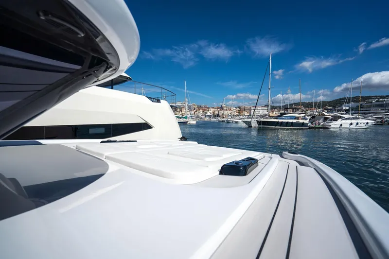 R2d2 Yacht Photos Pics 2025 Sunreef 55 Ultima yacht docked in a scenic marina under a clear blue sky.