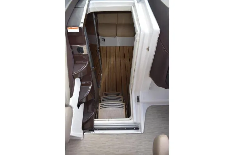  Yacht Photos Pics Interior view of 2015 Regal 32 Express boat cabin with wooden flooring.