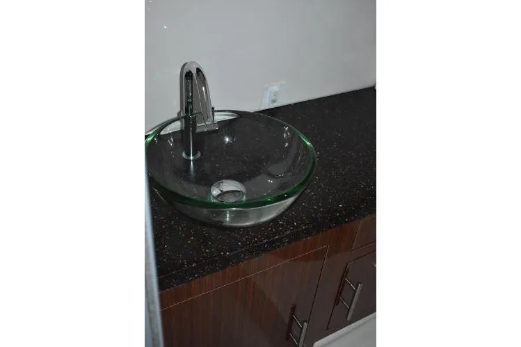  Yacht Photos Pics Glass vessel sink on dark countertop in 2015 Regal 32 Express boat bathroom.