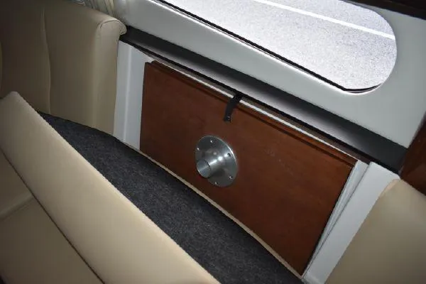  Yacht Photos Pics Interior view of 2015 Regal 32 Express boat with beige seating and wooden panel.