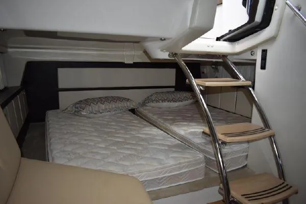  Yacht Photos Pics 2015 Regal 32 Express cabin with twin beds and wooden ladder.