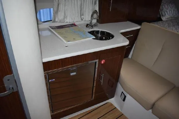  Yacht Photos Pics 2015 Regal 32 Express boat interior with kitchenette, sink, and seating area.