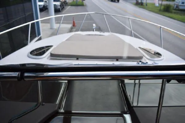  Yacht Photos Pics 2015 Regal 32 Express boat deck view with railing and sunpad.