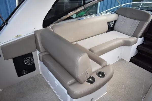  Yacht Photos Pics 2015 Regal 32 Express boat interior with beige seating and cup holders.