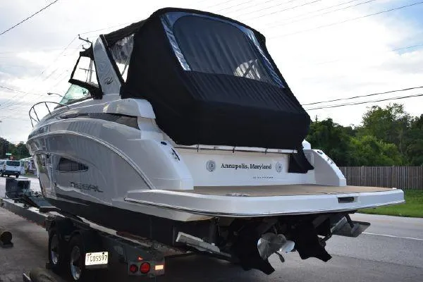  Yacht Photos Pics 2015 Regal 32 Express boat on trailer, rear view, black cover, Annapolis, Maryland.