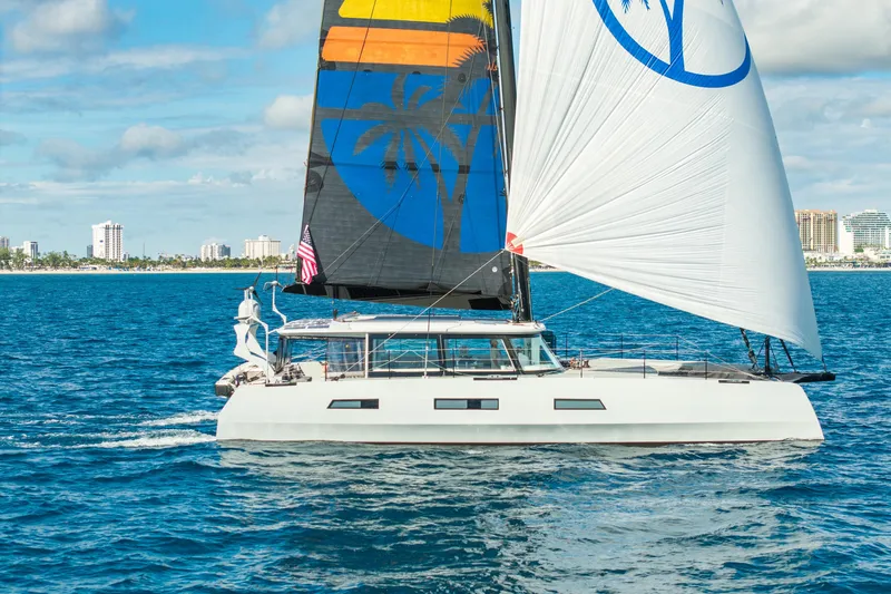 Crux Yacht Photos Pics Sailing yacht Harvey Yachts 58, 2017 model, cruising on blue ocean near city skyline.