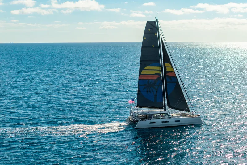 Crux Yacht Photos Pics Sailing yacht Harvey Yachts 58 (2017) on open sea with colorful sail design.