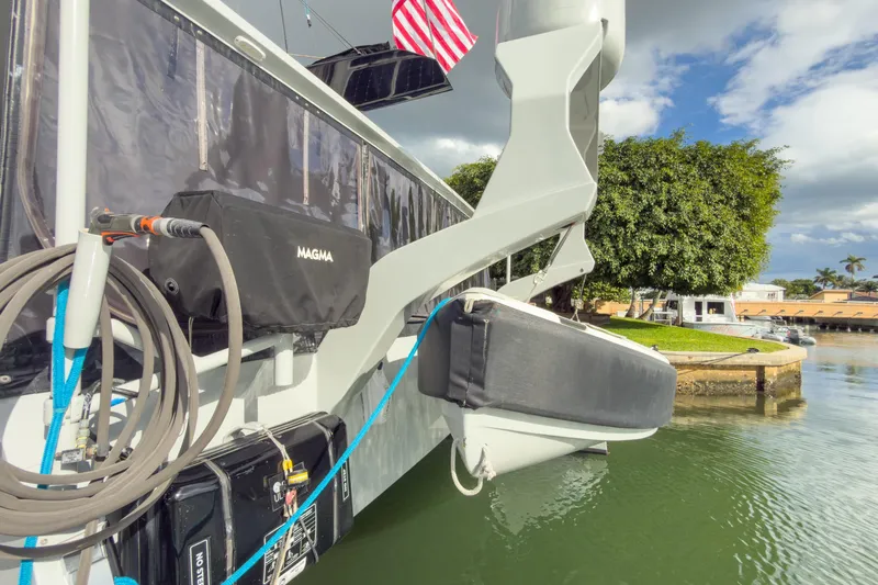 Crux Yacht Photos Pics 2017 Harvey Yachts 58 docked, featuring equipment and American flag, with scenic waterfront view.