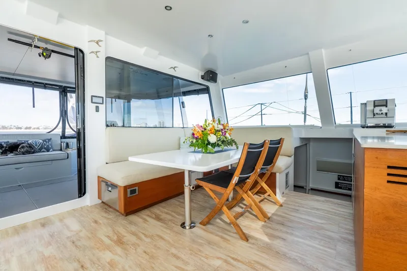 Crux Yacht Photos Pics Luxurious interior of 2017 Harvey Yachts 58, featuring elegant seating and a dining area.