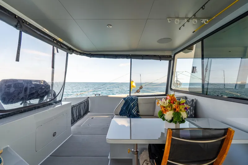 Crux Yacht Photos Pics Luxurious interior of 2017 Harvey Yachts 58 with ocean view and floral centerpiece.