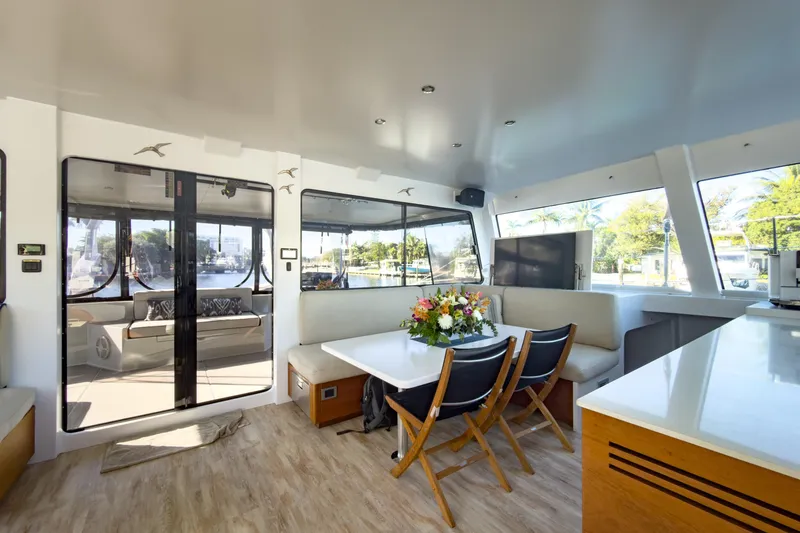 Crux Yacht Photos Pics Luxurious interior of 2017 Harvey Yachts 58, featuring elegant dining area and panoramic windows.