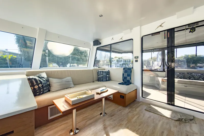 Crux Yacht Photos Pics Luxurious interior of 2017 Harvey Yachts 58, featuring elegant seating and panoramic windows.