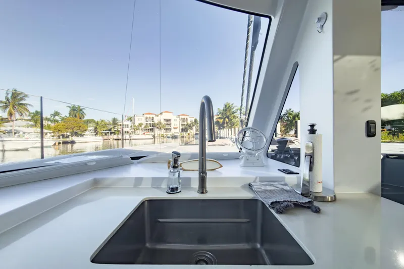 Crux Yacht Photos Pics Modern kitchen sink on 2017 Harvey Yachts 58, with marina view through large windows.