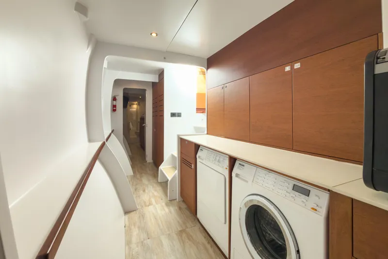 Crux Yacht Photos Pics Laundry area on 2017 Harvey Yachts 58, featuring modern appliances and wood cabinetry.