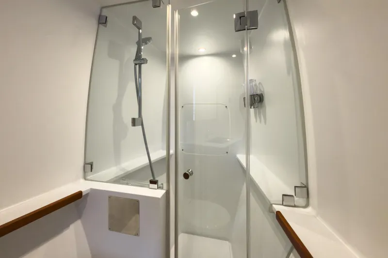 Crux Yacht Photos Pics Modern shower cabin on 2017 Harvey Yachts 58, featuring sleek glass doors and chrome fixtures.