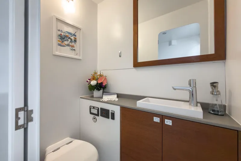 Crux Yacht Photos Pics Modern bathroom on 2017 Harvey Yachts 58, featuring sleek sink, mirror, and floral decor.