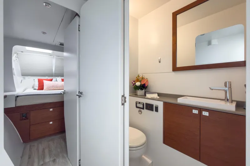 Crux Yacht Photos Pics Luxurious bathroom and bedroom interior of 2017 Harvey Yachts 58, featuring modern design and amenities.