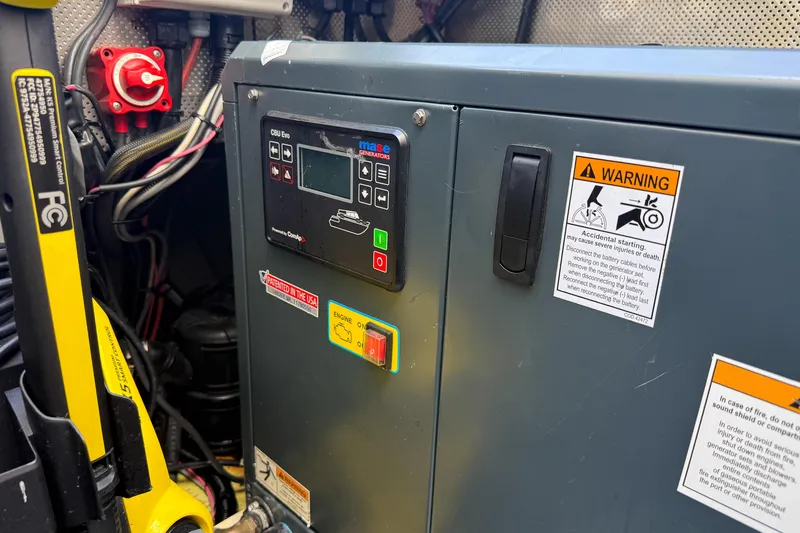 Crux Yacht Photos Pics Control panel of a 2017 Harvey Yachts 58, featuring warning labels and wiring.