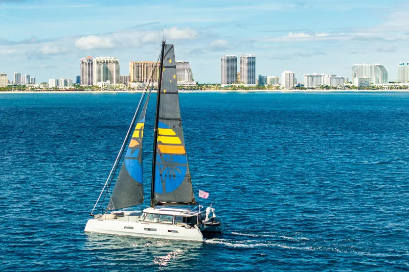 Crux Yacht Photos Pics Sailing yacht Harvey Yachts 58, 2017 model, cruising near a city skyline.